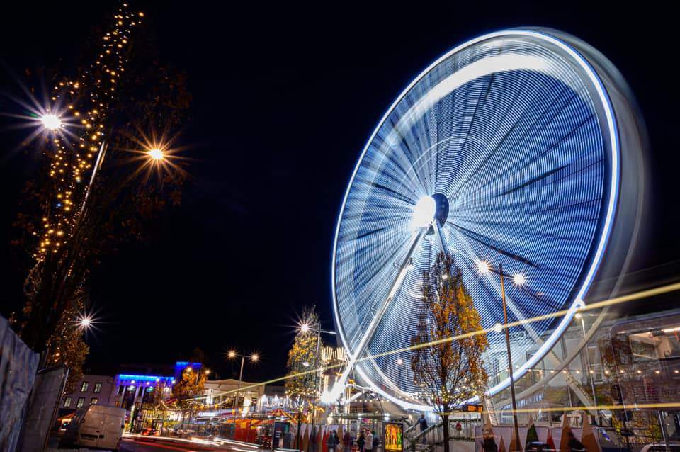 An illuminated Big Wheel spins in the darkness of night at the Galway Christmas Market.